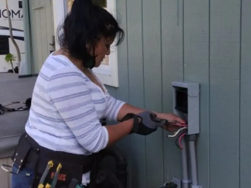 Licensed electrician wiring an exterior subpanel in Stanton